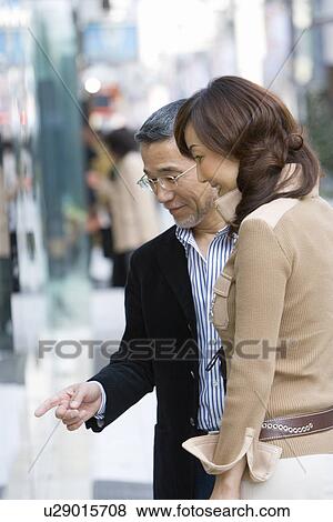 A Mature Adult Couple Looking into the Window of a Shop on a Street, Side View, Differential Focus View Large Photo Image Stock Photo - A Mature Adult Couple Looking into the Window of a Shop on a Street, Side View, Differential Focus. Fotosearch