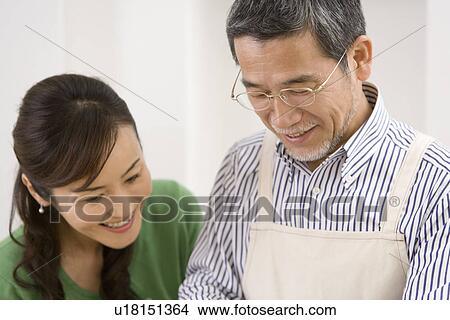 A Mature Adult Couple Smiling and Looking Down, Front View, Side View View Large Photo Image Picture - A Mature Adult Couple Smiling and Looking Down, Front View, Side View. Fotosearch