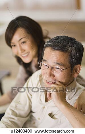 A Mature Adult Couple Smiling and Relaxing, Side View, Differential Focus View Large Photo Image Stock Image - A Mature Adult Couple Smiling and Relaxing, Side View, Differential Focus. Fotosearch