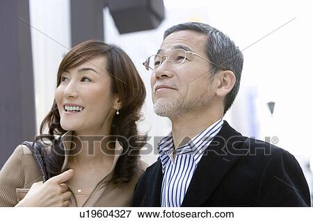 A Mature Adult Couple Smiling and Looking Away, Side View, Differential Focus View Large Photo Image Stock Photo - A Mature Adult Couple Smiling and Looking Away, Side View, Differential Focus. Fotosearch