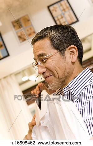 A Mature Adult Man Choosing Clothes, Side View, Differential Focus, Close Up View Large Photo Image Stock Image - A Mature Adult Man Choosing Clothes, Side View, Differential Focus, Close Up. Fotosearch