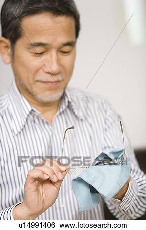 A Mature Adult Man Cleaning Glasses, Front View, Side View, Differential Focus View Large Photo Image Stock Photograph - A Mature Adult Man Cleaning Glasses, Front View, Side View, Differential Focus. Fotosearch