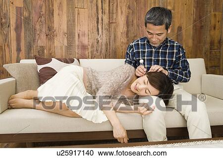 A Mature Adult Man Cleaning His Wife's Ear, Front View, Side View View Large Photo Image Stock Image - A Mature Adult Man Cleaning His Wife's Ear, Front View, Side View. Fotosearch