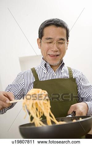 A Mature Adult Man Cooking Spaghetti, Front View View Large Photo Image Stock Image - A Mature Adult Man Cooking Spaghetti, Front View. Fotosearch