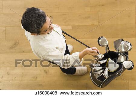 A Mature Adult Man Holding a Golf Club, High Angle View View Large Photo Image Stock Photo - A Mature Adult Man Holding a Golf Club, High Angle View. Fotosearch