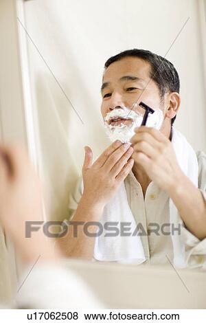 A Mature Adult Man Shaving Reflected in a Mirror, Front View, Side View, Differential Focus View Large Photo Image Stock Photo - A Mature Adult Man Shaving Reflected in a Mirror, Front View, Side View, Differential Focus. Fotosearch
