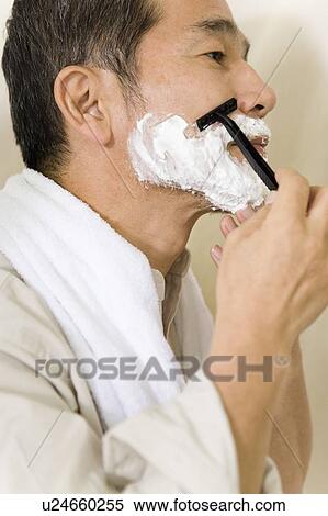 Stock Photography - A Mature Adult Man Shaving, Side View. Fotosearch