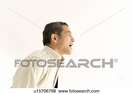 Stock Photo - A Mature Adult Man Singing, Side View, Copy Space. Fotosearch