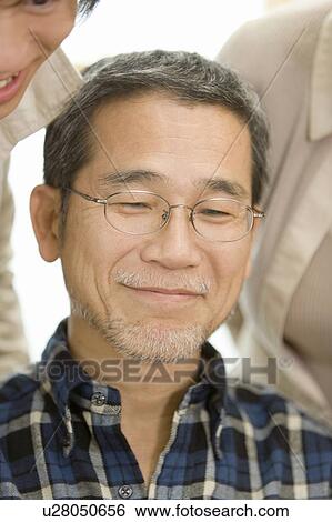A Mature Adult Man Smiling with Two Others, Front View, Close Up, Differential Focus View Large Photo Image Stock Photograph - A Mature Adult Man Smiling with Two Others, Front View, Close Up, Differential Focus. Fotosearch