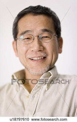 Stock Image - A Portrait of a Mature Adult Man Smiling at Camera, Front View. Fotosearch