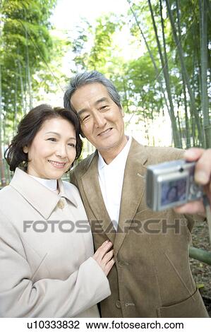 A Senior Adult Couple Taking a Picture of Themselves, Front View, Side View, Differential Focus View Large Photo Image Stock Image - A Senior Adult Couple Taking a Picture of Themselves, Front View, Side View, Differential Focus. Fotosearch