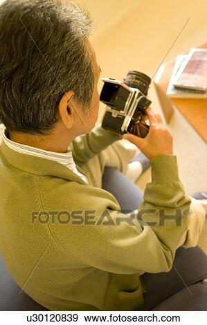 A Senior Adult Man Caring His Camera, Rear View, High Angle View View Large Photo Image Stock Photo - A Senior Adult Man Caring His Camera, Rear View, High Angle View. Fotosearch
