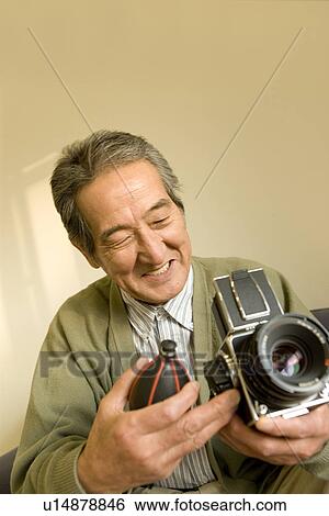 A Senior Adult Man Caring His Camera, Front View View Large Photo Image Stock Photograph - A Senior Adult Man Caring His Camera, Front View. Fotosearch