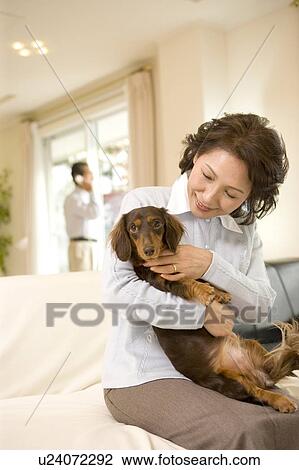 A Senior Adult Woman Holding a Dog in a Living Room, Front View, Side View, Differential Focus View Large Photo Image Stock Image - A Senior Adult Woman Holding a Dog in a Living Room, Front View, Side View, Differential Focus. Fotosearch