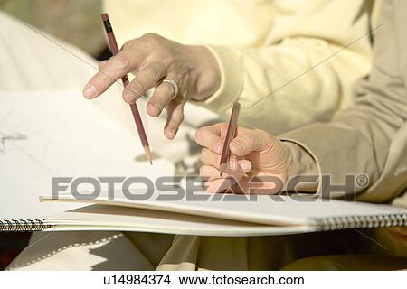 Closed Up Image of Hands Holding a Pencil and Sketching, Differential Focus View Large Photo Image Picture - Closed Up Image of Hands Holding a Pencil and Sketching, Differential Focus. Fotosearch