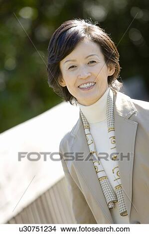 Picture - Portrait of a Mature Smiling Woman, Waist Up, Differential Focus, Front View. Fotosearch
