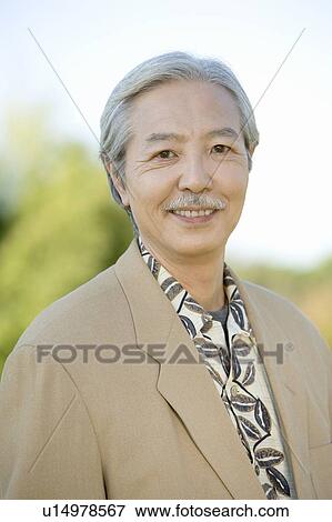 Stock Photo - Portrait of Mature, Smiling Man Looking at Camera, Head and Shoulder, Front View, Differential Focus. Fotosearch