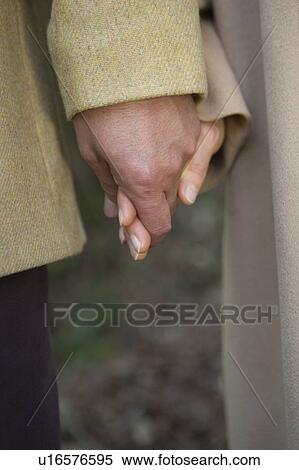 Stock Photography - Close-up Image of Hands of Mature Adult Couple. Fotosearch