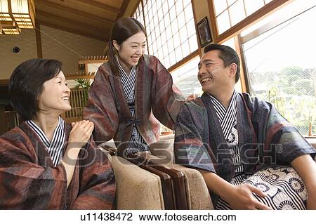 Stock Image - Mature Adult Couple and their Daughter at a Hot Spring Resort, Side View, Front View, Waist Up. Fotosearch
