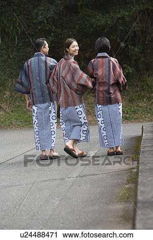 Mature Adult Couple and their Daughter Walking Arm in Arm, Rear View, Full Length, Looking at Camera View Large Photo Image Stock Image - Mature Adult Couple and their Daughter Walking Arm in Arm, Rear View, Full Length, Looking at Camera. Fotosearch