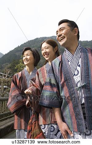 Mature Adult Couple and their Daughter Smiling and Looking Away, Side View, Three Quarter Length, Low Angle View View Large Photo Image Stock Photo - Mature Adult Couple and their Daughter Smiling and Looking Away, Side View, Three Quarter Length, Low Angle View. Fotosearch