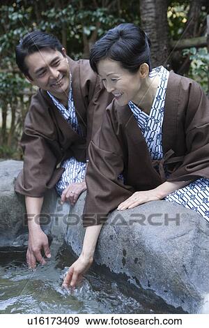 Mature Adult Couple Crouching and Touching Water, Side View, Waist Up View Large Photo Image Stock Photo - Mature Adult Couple Crouching and Touching Water, Side View, Waist Up. Fotosearch