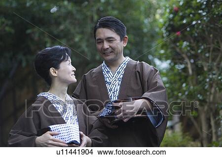 Mature Adult Couple Holding Wooden Pails and Looking at Each Other, Front View, Side View, Waist Up, Differential Focus View Large Photo Image Picture - Mature Adult Couple Holding Wooden Pails and Looking at Each Other, Front View, Side View, Waist Up, Differential Focus. Fotosearch