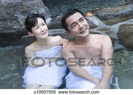 Stock Photography - Mature Adult Couple Soaking in a Hot Spring Together, Front View, Three Quarter Length, High Angle View. Fotosearch