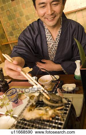 Mature Adult Man Trying to Pick Up Food with Chopsticks, Front View, Differential Focus View Large Photo Image Stock Image - Mature Adult Man Trying to Pick Up Food with Chopsticks, Front View, Differential Focus. Fotosearch