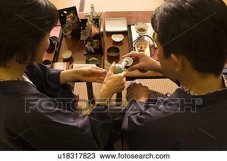 Mature Adult Woman Pouring Her Husband, Rear View, High Angle View, Head and Shoulder View Large Photo Image Stock Image - Mature Adult Woman Pouring Her Husband, Rear View, High Angle View, Head and Shoulder. Fotosearch