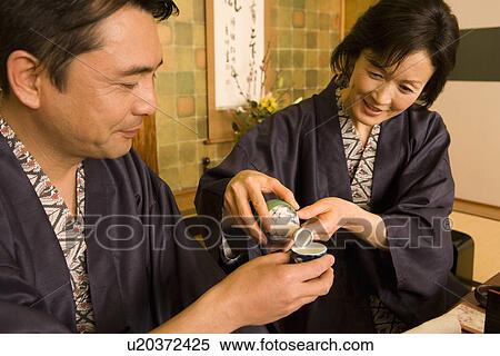 Mature Adult Woman Pouring Her Husband, Side View, Waist Up View Large Photo Image Stock Photography - Mature Adult Woman Pouring Her Husband, Side View, Waist Up. Fotosearch