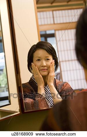 Mature Adult Woman Reflected in a Mirror, Front View, Head and Shoulder View Large Photo Image Stock Photo - Mature Adult Woman Reflected in a Mirror, Front View, Head and Shoulder. Fotosearch