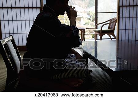Stock Photo - Silhouette Image of a Mature Adult Man Drinking Tea, Side View, Three Quarter Length. Fotosearch