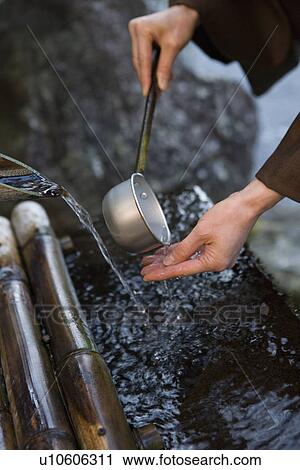 Stock Image - Washing Hands with a Ladle, Close Up, High Angle View, . Fotosearch