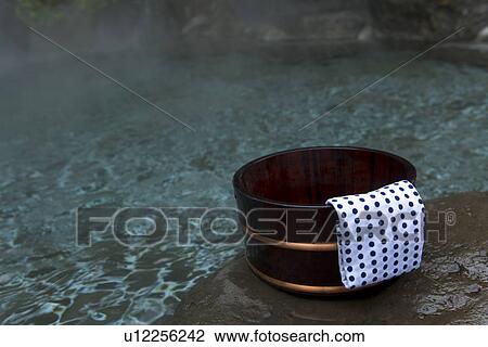Stock Image - Image of a Japanese Outdoor Hot Spring Bath, Tub and Tenugui at the Side, Close Up. Fotosearch