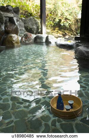 Stock Photography - Image of a Japanese Outdoor Hot Spring Bath, Sake Bottle and Cups in a Floating Tub, High Angle View. Fotosearch