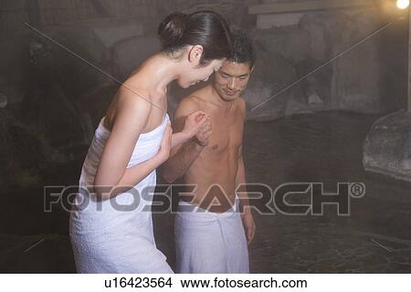 Mid Adult Couple Going Down into the Outdoor Hot Spring Bath, Side View View Large Photo Image Picture - Mid Adult Couple Going Down into the Outdoor Hot Spring Bath, Side View. Fotosearch