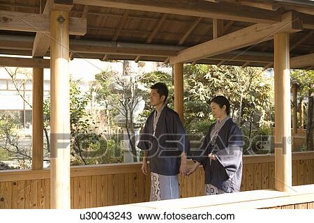 Mid Adult Couple in Yukata, Walking on the Outside Corridor, Holding Hands, Side View View Large Photo Image Stock Image - Mid Adult Couple in Yukata, Walking on the Outside Corridor, Holding Hands, Side View. Fotosearch