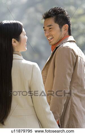 Mid Adult Couple Smiling at Each Other, Rear View, Side View View Large Photo Image Stock Photography - Mid Adult Couple Smiling at Each Other, Rear View, Side View. Fotosearch
