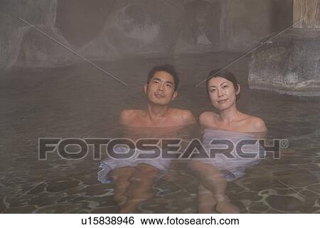 Mid Adult Couple Soaking in the Outdoor Hot Spring Bath Together, Front View View Large Photo Image Stock Photograph - Mid Adult Couple Soaking in the Outdoor Hot Spring Bath Together, Front View. Fotosearch