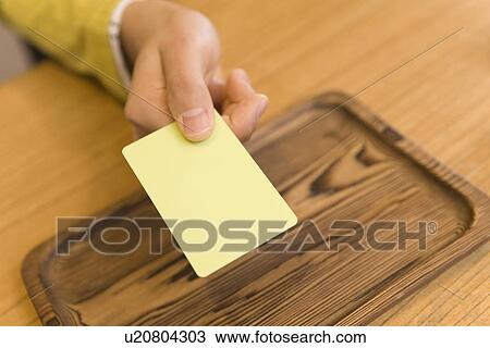 Man holding a card at the hotel reception, high angle view, close up, Japan View Large Photo Image Stock Image - Man holding a card at the hotel reception, high angle view, close up, Japan. Fotosearch