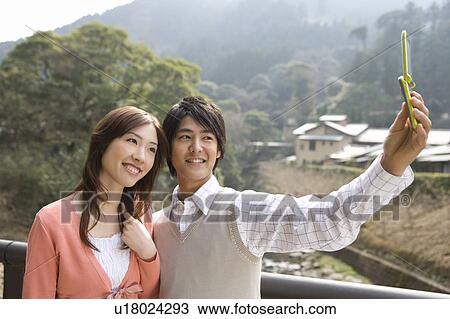 Man taking a picture of themselves with a mobile phone, side view, Japan View Large Photo Image Stock Image - Man taking a picture of themselves with a mobile phone, side view, Japan. Fotosearch