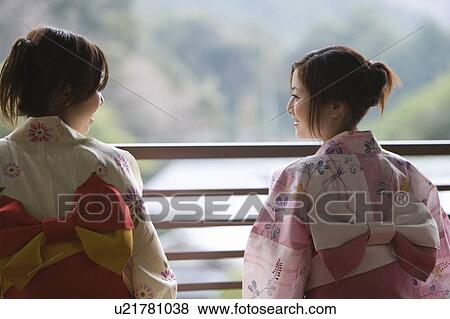 Two women in Yukata talking by the railing, rear view, differential focus, Japan View Large Photo Image Stock Photo - Two women in Yukata talking by the railing, rear view, differential focus, Japan. Fotosearch