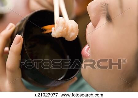 Woman holding a shrimp with chopsticks, high angle view, close up, Japan View Large Photo Image Stock Photo - Woman holding a shrimp with chopsticks, high angle view, close up, Japan. Fotosearch