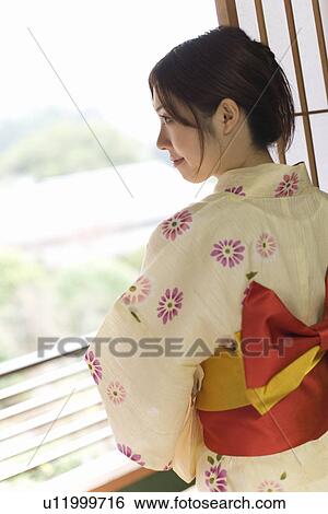 Woman in Yukata looking outside from the window, rear view, Japan View Large Photo Image Stock Photograph - Woman in Yukata looking outside from the window, rear view, Japan. Fotosearch