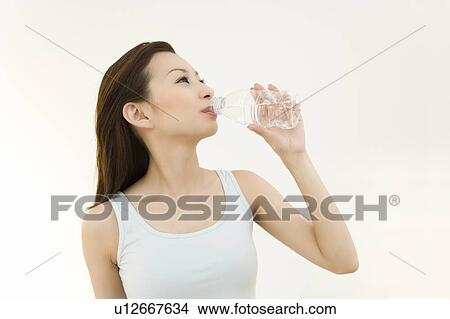 Picture - A woman drinking water, front view, white background. Fotosearch