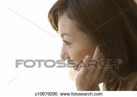 A woman putting chin on her hand, side view, close up, white background View Large Photo Image Stock Image - A woman putting chin on her hand, side view, close up, white background. Fotosearch