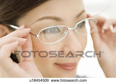 A woman wearing glasses, side view, close up, differential focus View Large Photo Image Stock Photo - A woman wearing glasses, side view, close up, differential focus. Fotosearch