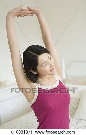 Young Woman Stretching, Arms Raised, Smiling, Side View View Large Photo Image Stock Image - Young Woman Stretching, Arms Raised, Smiling, Side View. Fotosearch