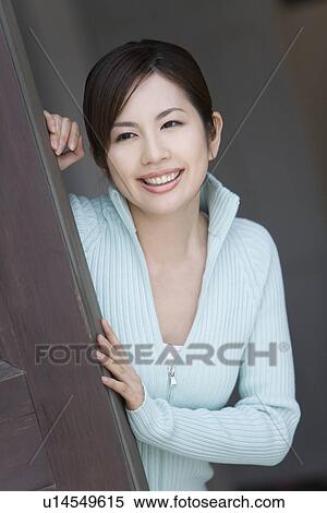 A Smiling Young Woman Leaning Over on the Door, Front View View Large Photo Image Stock Photography - A Smiling Young Woman Leaning Over on the Door, Front View. Fotosearch